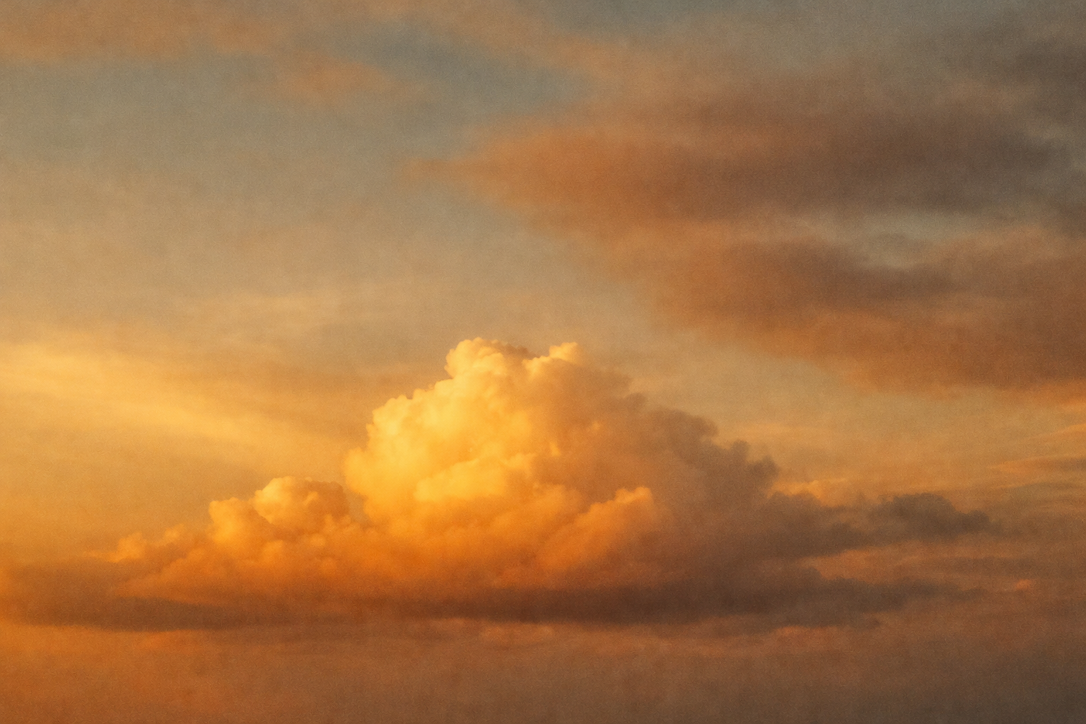 Warm golden clouds illuminated at sunset, creating a peaceful and uplifting sky background inspired by faith and hope.